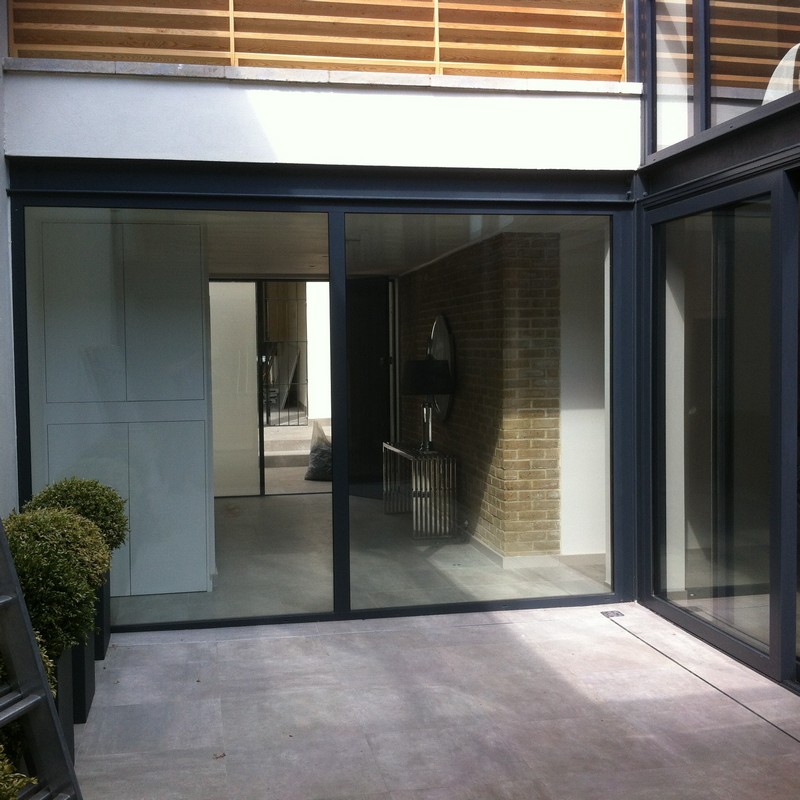 Floor-to-ceiling sliding doors opening to courtyard in Harrow